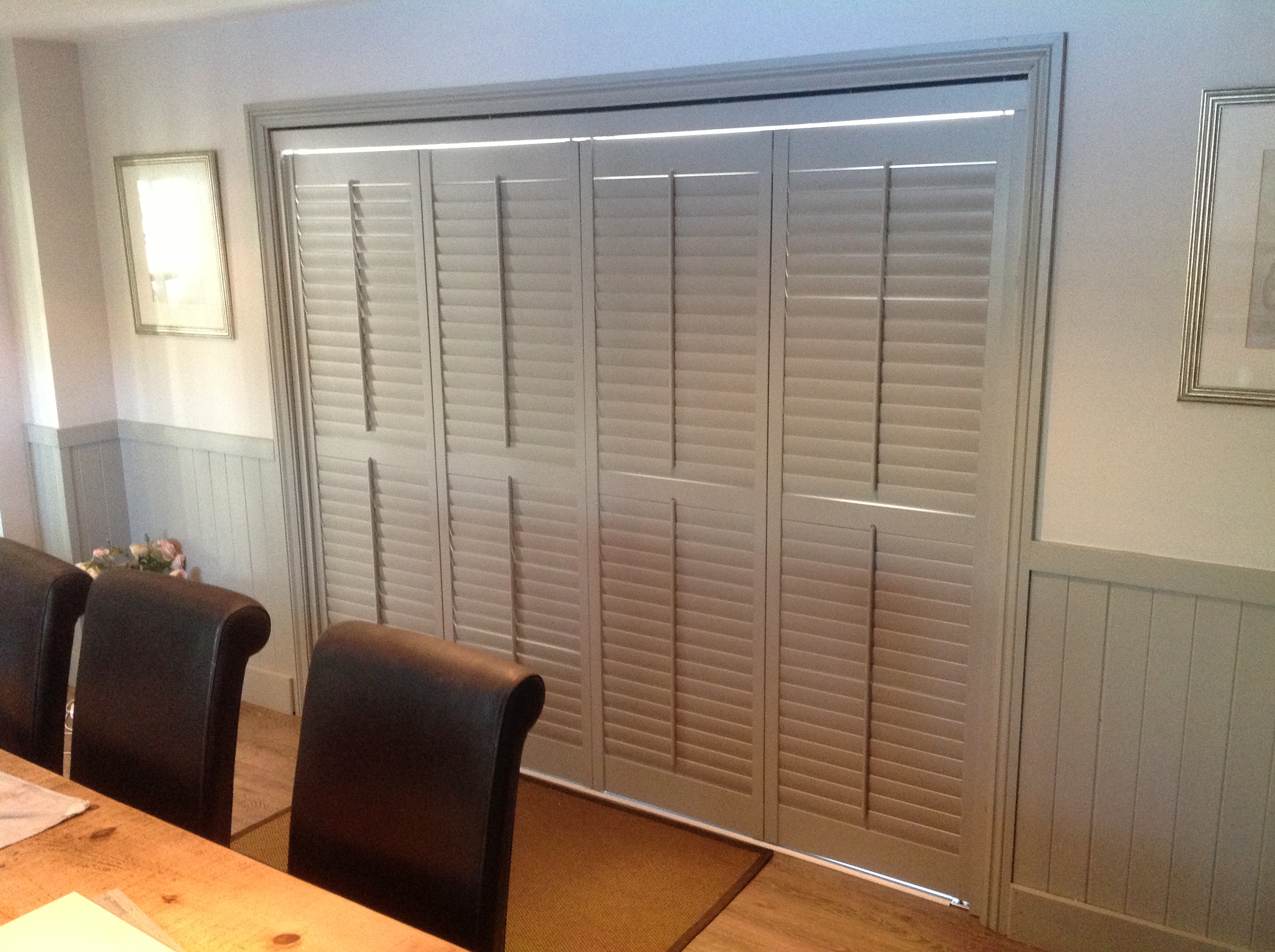 Custom colour Farrow and Ball Bi folding shutters on track system  - Plantation shutters -  Carolina Blinds