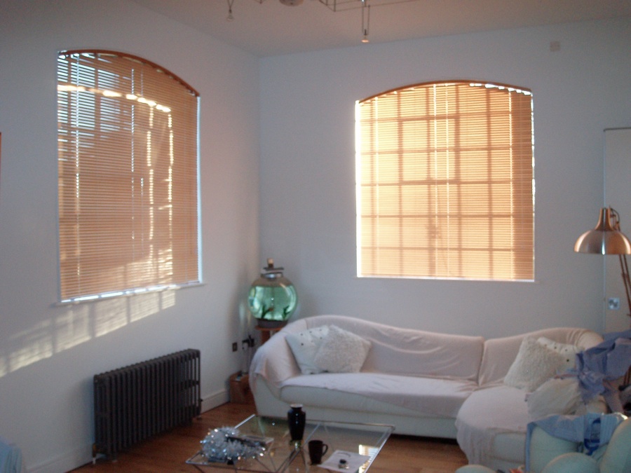 Arched wood effect 25mm venetian blinds fitted in flat in Standon. A template was taken of each window to get arch.  - Venetian and wooden blinds -  Carolina Blinds